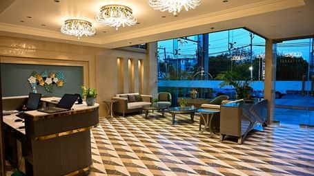 A spacious lobby featuring comfortable seating arrangements and a reception desk at 